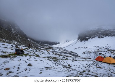 View of snow covered Rupin pass trek campsite. This trek is full of diversity from majestic Himalayan ranges to waterfalls, glacial meadows, snow-covered landscapes, lush forests in Himachal, India. - Powered by Shutterstock