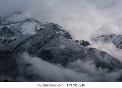 View of snow mountain surrounded by clouds with morning fog