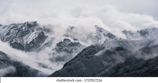 View of snow mountain surrounded by clouds with morning fog - Powered by Shutterstock