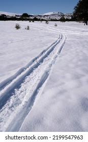 View of snowmobile tracks in the mountain snow field, in winter.