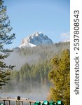 View of a snowy mountain peak in the Sawtooth Mountain Rage from Redfish Lake in November. SHOTLIST. Stay in log cabins with this view. fireplaces, and gourmet breakfasts.