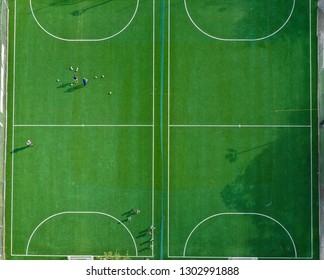 View Of Soccer Pitches From Overhead. These Are Soccer Cages In Miami Freshly Redone. Green, People On Pitch Getting Ready To Train.