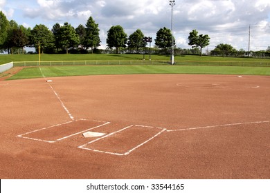 A View Of A Softball Diamond At Dusk.