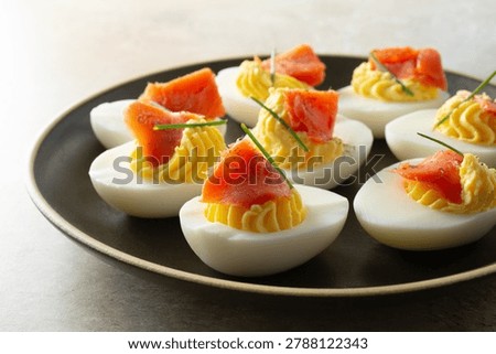 A view of some deviled eggs, featuring smoked salmon.