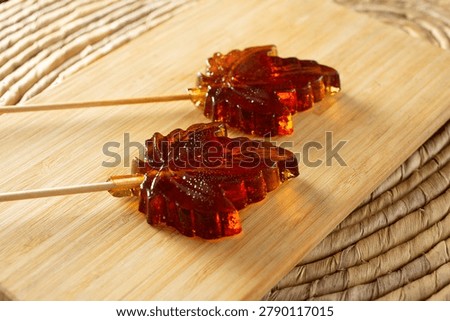 A view of some maple leaf hard candy lollipops.