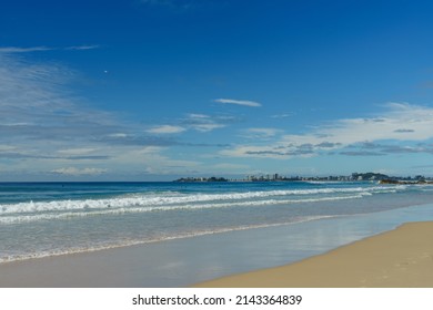 View south from Currumbin Beach, across the water to Coolangatta in the distance. Blue sky with white and grey clouds. Gold Coast, Queensland, Australia.