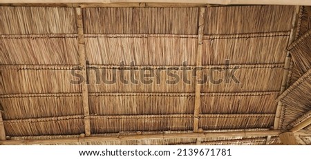 View from the southern side of a traditional thatched roof in a rural village. That thatched roof can be sunproof and rainproof. And good ventilation The history of hay or old hay.Straw Roof abstract 