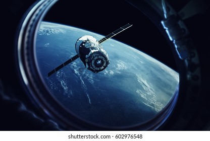 View From Spaceship Porthole. Earth And Spacecraft. Elements Of This Image Furnished By NASA