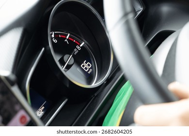 A view of a speedometer in a moving car, close up.