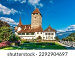 View of Spiez Church and Castle on the shore of Lake Thun in the Swiss canton of Bern at sunset, Spiez, Switzerland. Spiez Castle on lake Thun in the canton of Bern, Switzerland.
