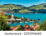 View of Spiez Church and town on the shore of Lake Thun in the Swiss canton of Bern at sunset, Spiez, Switzerland. Spiez city on lake Thun in the canton of Bern, Switzerland.