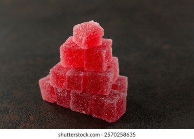 A view of a stack of edible red sour candy.