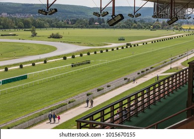 A view from the stand on an empty racing track. Treated green grass ready for horse racing in sunny day.