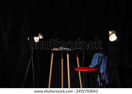 View of standup scene with table, stool and glowing lamps