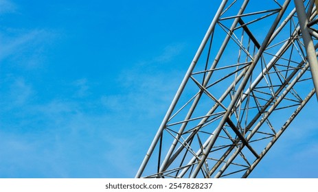 view of a steel lattice structure against a clear blue sky. - Powered by Shutterstock