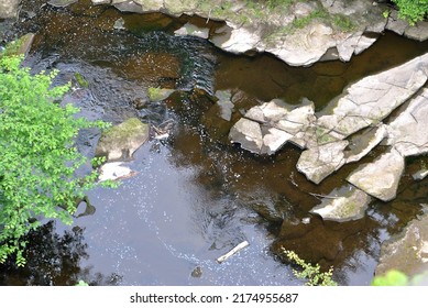 View Of Still Waters Of River With Rocks Seen From Above 