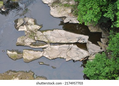 View Of Still Waters Of River With Rocks Seen From Above 