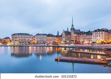 View of Stockholm old town at dusk. Long exposure shot, with water on foreground and blurred clouds on the sky. Typical scandinavian architecture and colors. Travel and tourism concept.