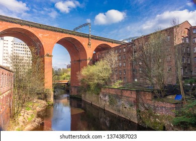 View of Stockport railway viaduct over the River Mersey, with the new road bridge, built 2019. visible through the centre arch. Stockport, Cheshire, UK.