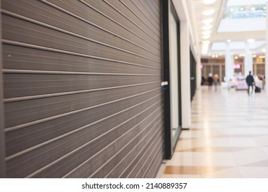 View of stores show case in shopping mall closed due to sanctions and embargo, mass market cloth shops work stoppage with closed storefronts, retail business suspension and brands leaving market - Shutterstock ID 2140889357