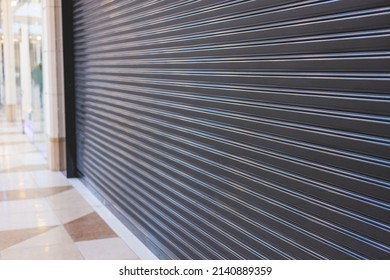 View of stores show case in shopping mall closed due to sanctions and embargo, mass market cloth shops work stoppage with closed storefronts, retail business suspension and brands leaving market - Shutterstock ID 2140889359