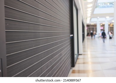View of stores show case in shopping mall closed due to sanctions and embargo, mass market cloth shops work stoppage with closed storefronts, retail business suspension and brands leaving market - Shutterstock ID 2140889367