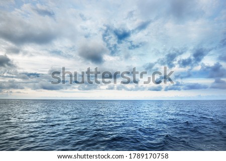 A view of the stormy North sea from a sailing boat. Cloudy blue sky reflecting in the water. Dramatic cloudscape. Rogaland region, Norway. Leisure activity, environmental conservation concepts