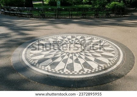 View of Strawberry Fields Memorial in Central Park, New York City, honoring Beatles legend John Lennon and named after their iconic song 'Strawberry Fields Forever,' composed by Lennon