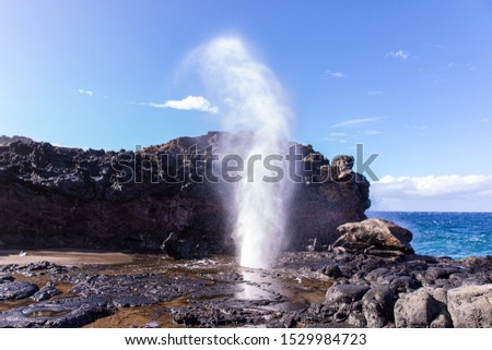 View at a stream of water and steam exploding from Nakalee blowhole, Maui, Hawaii