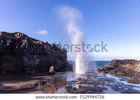 View at a stream of water and steam exploding from Nakalee blowhole, Maui, Hawaii