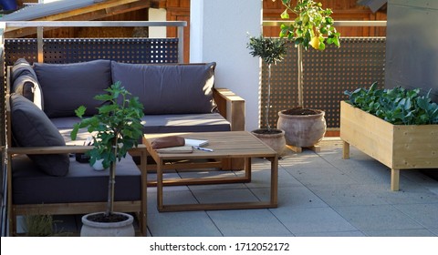 View of a stylish sitting area surrounded by mediterranean plants on a terrace