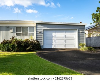View of suburban house with garage. Auckland, New Zealand - May 20, 2022