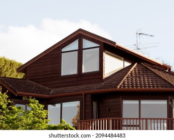 View Of Suburban House With Multi Faceted Metal Roof