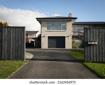 View of suburban painted brick house. Auckland, New Zealand - May 23, 2022