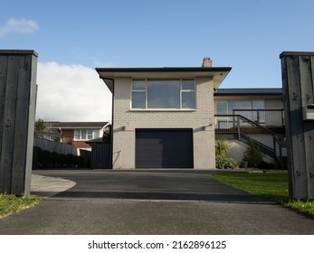 View of suburban painted brick house. Auckland, New Zealand - May 23, 2022