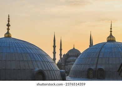 View of Sultanahmet Imperial Mosque, Sultan Ahmet Camii. Blue Mosque domes and minarets in Istanbul, Turkey at sunset.