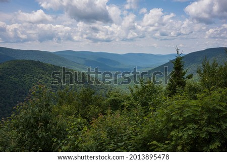 The view from the summit of Hunter Mountain, which is the highest peak of 4039-feet in the Catskill Mountains of New York State during sunny day with cumulus clouds. 