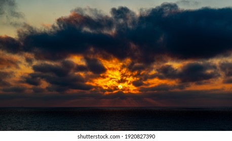 View to the sun covered by clouds on the sunset sky - Shutterstock ID 1920827390