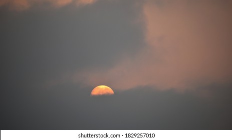 A View Of The Sun Emerging From Behind The Clouds