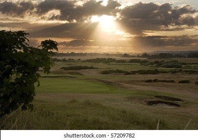 View Of Sunset Across Links Golf Course With Sun Beams