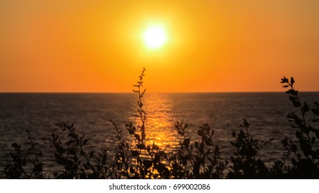 A View Of The Sunset At The Beach In Faro, Portugal