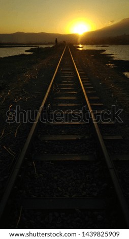 The view of sunset in the edge of rail train. 