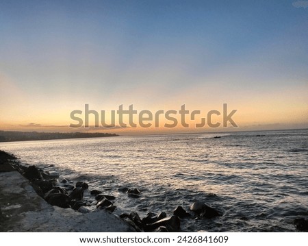 View of the sunset on the edge of Bahu Beach, Manado City, North Sulawesi, Indonesia in the afternoon.