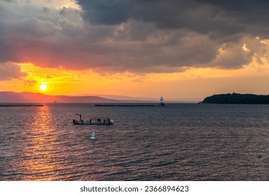 View of the sunset on Lake Champlain with view of the North Lighthouse and breakwater in Burlington, Vermont. - Powered by Shutterstock