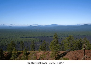 View of surrounding Cascade Mountain Range in the background as seen from the top of a lava butte, with the massive blanket of lava still covering the landscape. - Powered by Shutterstock