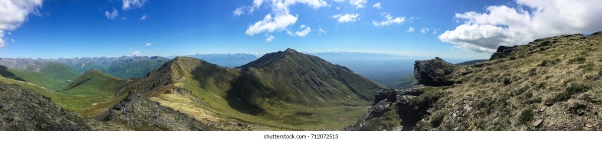 View of surrounding mountain range on a sunny day.