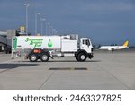 View of the Sustainable Aviation Fuel truck at the airport. Truck is waiting for aircraft refueling operation.