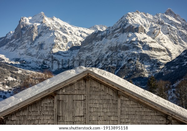 View of the Swiss mountains in winter.\
Mittelhornin clouds, Schreckhorn and Wetterhorn. Swiss alps in\
Jungfrauregion in\
Switzerland