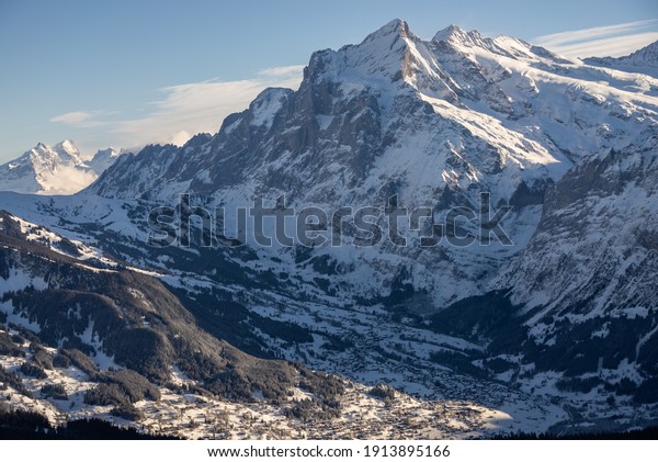 View of the Swiss mountains in winter.\
Mittelhornin clouds, Schreckhorn and Wetterhorn. Swiss alps in\
Jungfrauregion in\
Switzerland