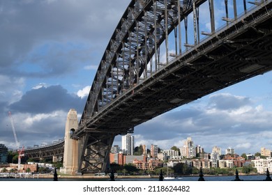 View Of Sydney Harbour Bridge From The City To Blues Point. Apartment Blocks Fill The Scene. A Construction Site With A Crane To The Left Where A Tunnel For The New Sydney Metro Is Being Built.